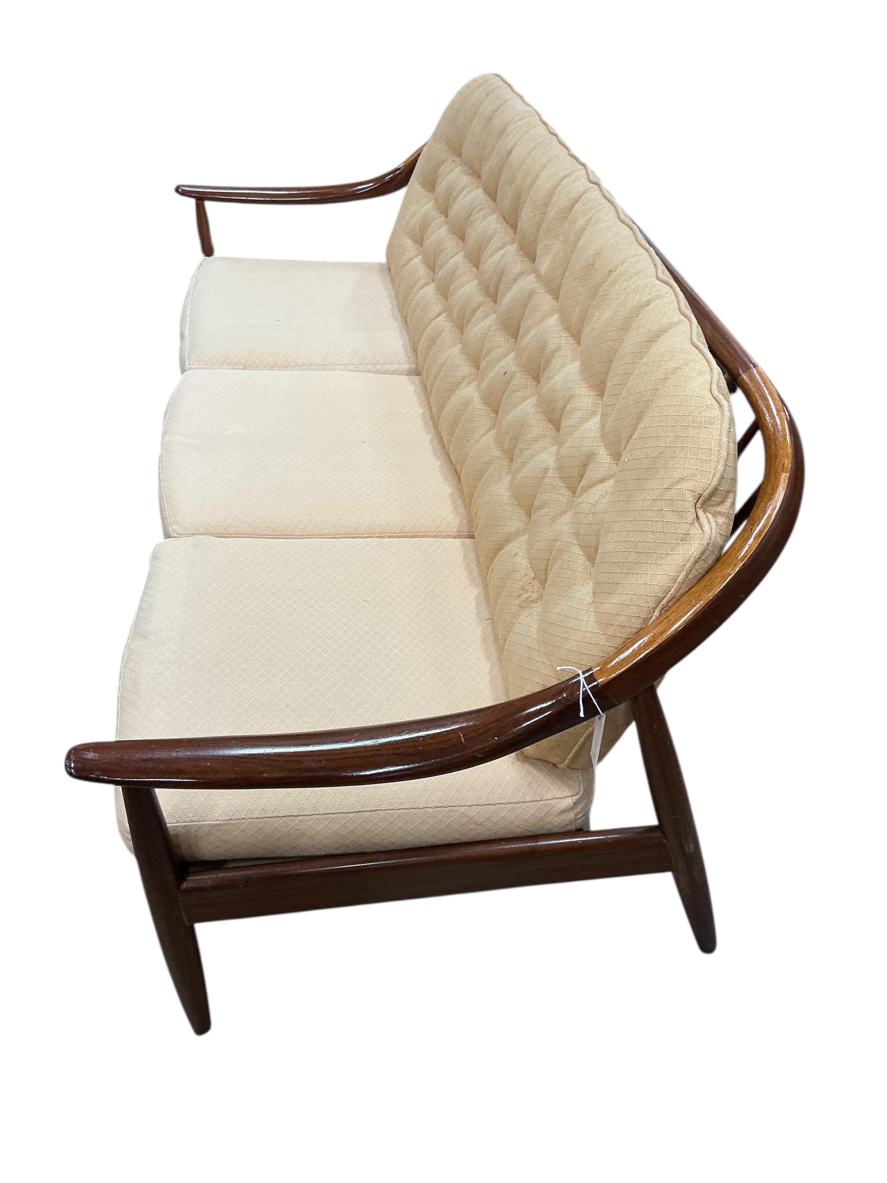 Greaves and Thomas: A mid century teak stick back sofa, width 168cm, depth 70cm, height 70cm